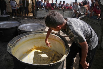Un niño rebaña los restos